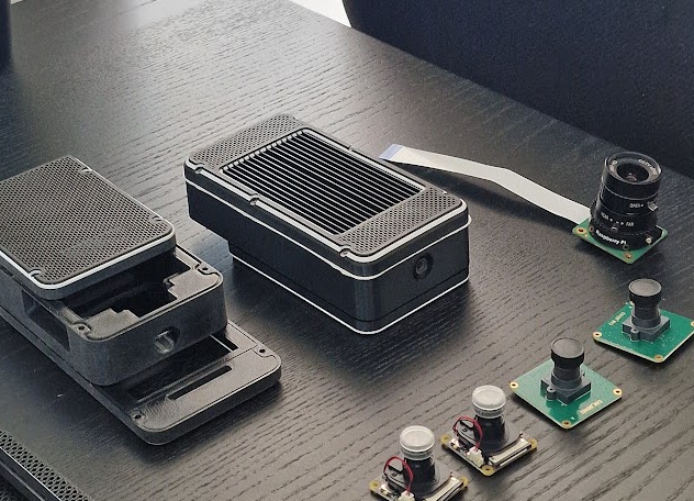 AI camera hardware with an assembled enclosure, separate housing parts and camera modules